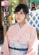 a woman in a pink kimono is posing for the camera