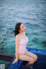 XiaoYu Vol.071: 绯 月樱 -Cherry (57 pictures) A woman in a pink bathing suit sitting on the edge of a pool.