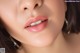 a close up of a woman's face with a pink lipstick